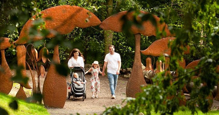 Family walking through the grounds of Durham Botanic Garden